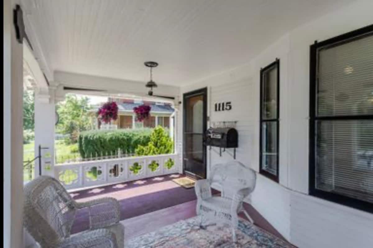 Covered front porch with a green porch swing