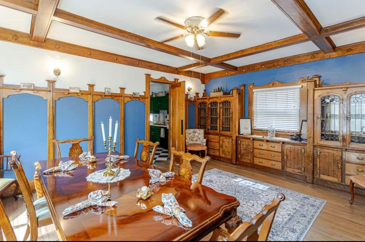 Dining room with wooden table, chairs and vintage hutch