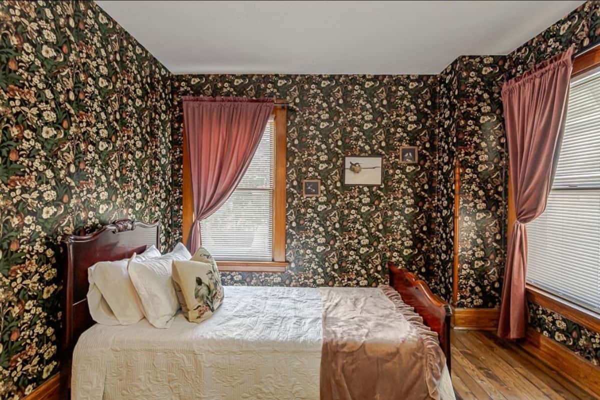 Comfortable bedroom with patterned rug and warm wood furniture